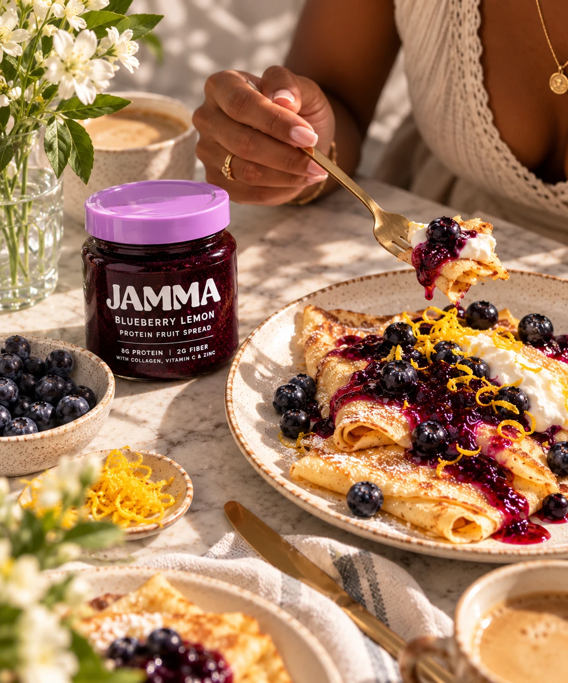 Golden crepes finished with blueberry preserves and fresh cream